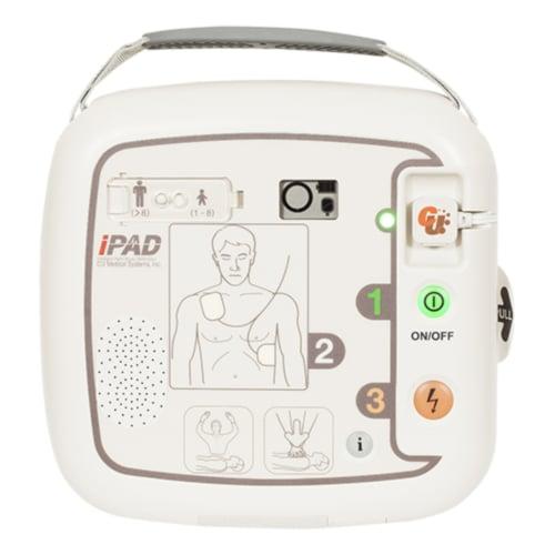 Vit CU Medical i-PAD SP1 hjärtstartare med bärhandtag, kontrollknappar och illustration för elektrodplacering.