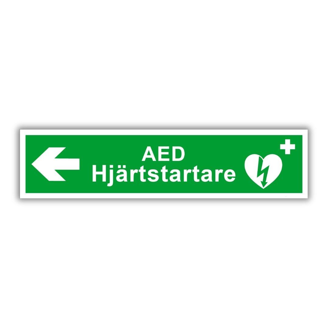Hänvisningsskylt med pil mot hjärtstartare AED