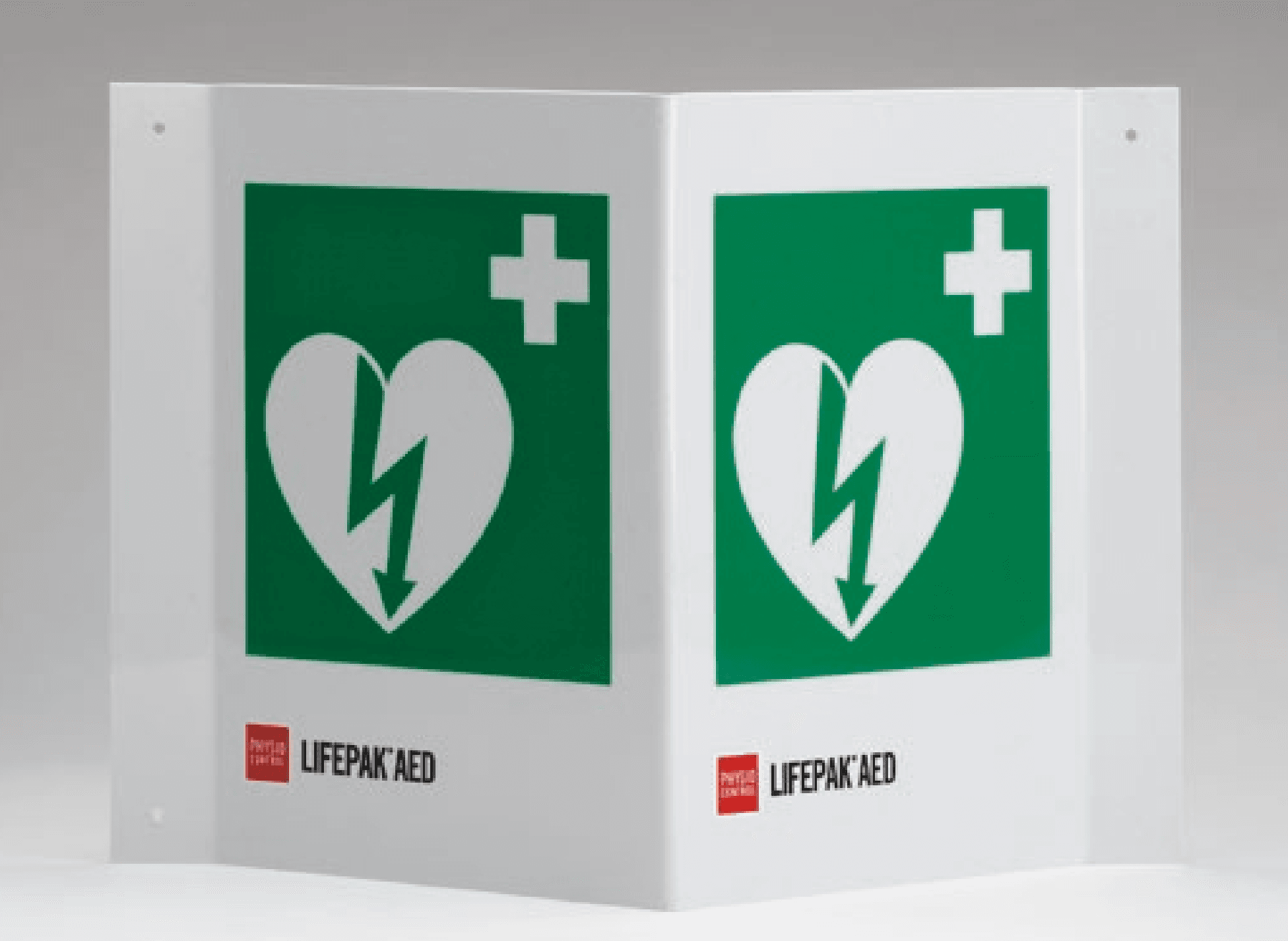 Vit vinklad skylt med grön ruta innehållande vita symboler i form av hjärta med blixt i och ett sjukvårdskors