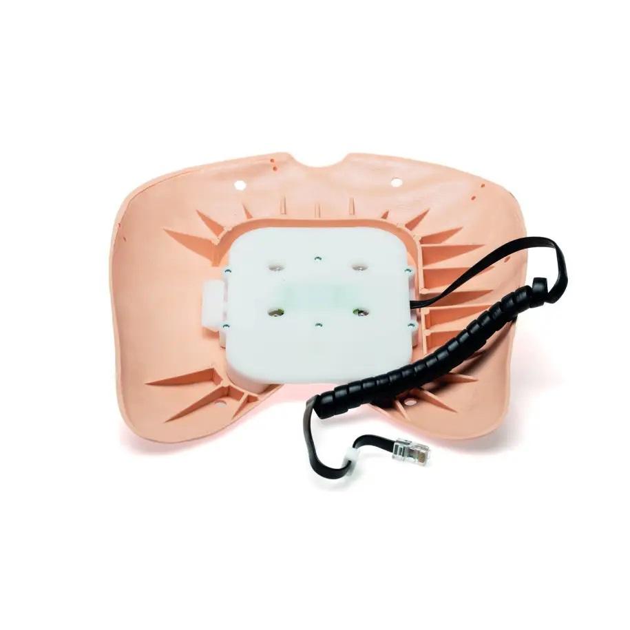 En beige platta med en vit fyrkantig sensor i mitten. Från sensorn går en svart sladd.